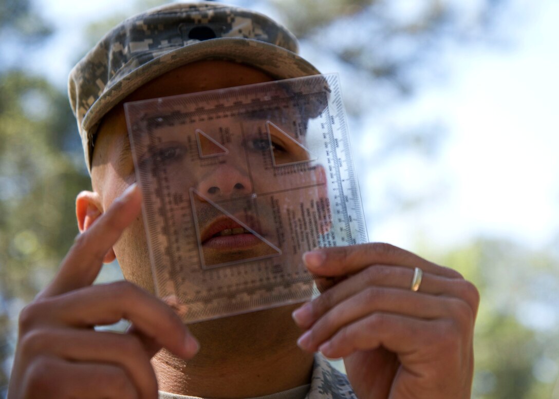 U.S. Army Spc. Luis Cruz, a cargo specialist assigned to the 688th Rapid Port Opening Element, analyzes a template during the 597th Transportation Brigade Best Warrior Competition at Fort Eustis, Va., April 15, 2016. Cruz used the template to plot points on his map during the land navigation portion of the competition. (U.S. Air Force photo by Staff Sgt. J.D. Strong II)
