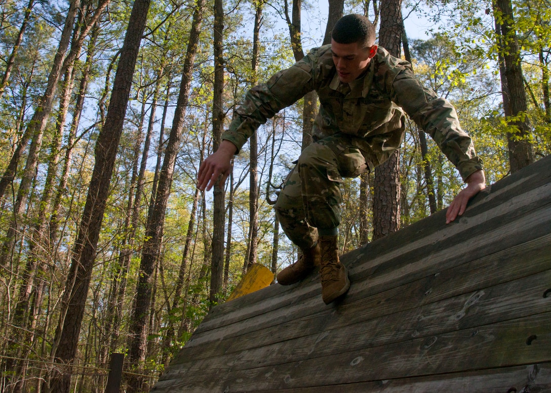 U.S. Army Spc. David Dell, a cargo specialist assigned to the 689th Rapid Port Opening Element, hurdles an obstacle course during the 597th Transportation Brigade Best Warrior Competition at Fort Eustis, Va., April 15, 2016. The obstacle course tested the Soldiers’ physical fitness. (U.S. Air Force photo by Staff Sgt. J.D. Strong II)