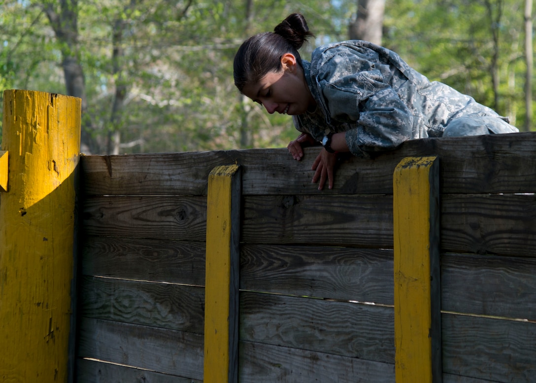 U.S. Army Spc. Diamantina Hernandez, a cargo specialist assigned to the 690th Rapid Port Opening Element, climbs an obstacle course wall during the 597th Transportation Brigade Best Warrior Competition at Fort Eustis, Va., April 15, 2016. The competition was a three-day event testing Soldiers’ physical abilities and Army knowledge. (U.S. Air Force photo by Staff Sgt. J.D. Strong II)