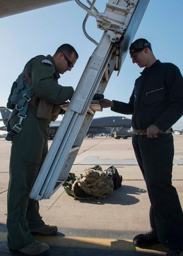 A 9th Bomb Squadron B-1B Lancer aircrew member, left, and Senior Airman Robert Shedd, 7th Aircraft Maintenance Squadron B-1B Lancer crew chief, review a flight manual before take-off during Exercise Constant Vigilance 16, April 10, 2016, at Dyess Air Force Base, Texas. Air Force Global Strike Command conducts exercises on a regular basis to ensure forces are ready to perform nuclear deterrence operations and deliver long-range strike capabilities at any given moment. (U.S. Air Force photo by Airman 1st Class Katherine Miller/Released) 