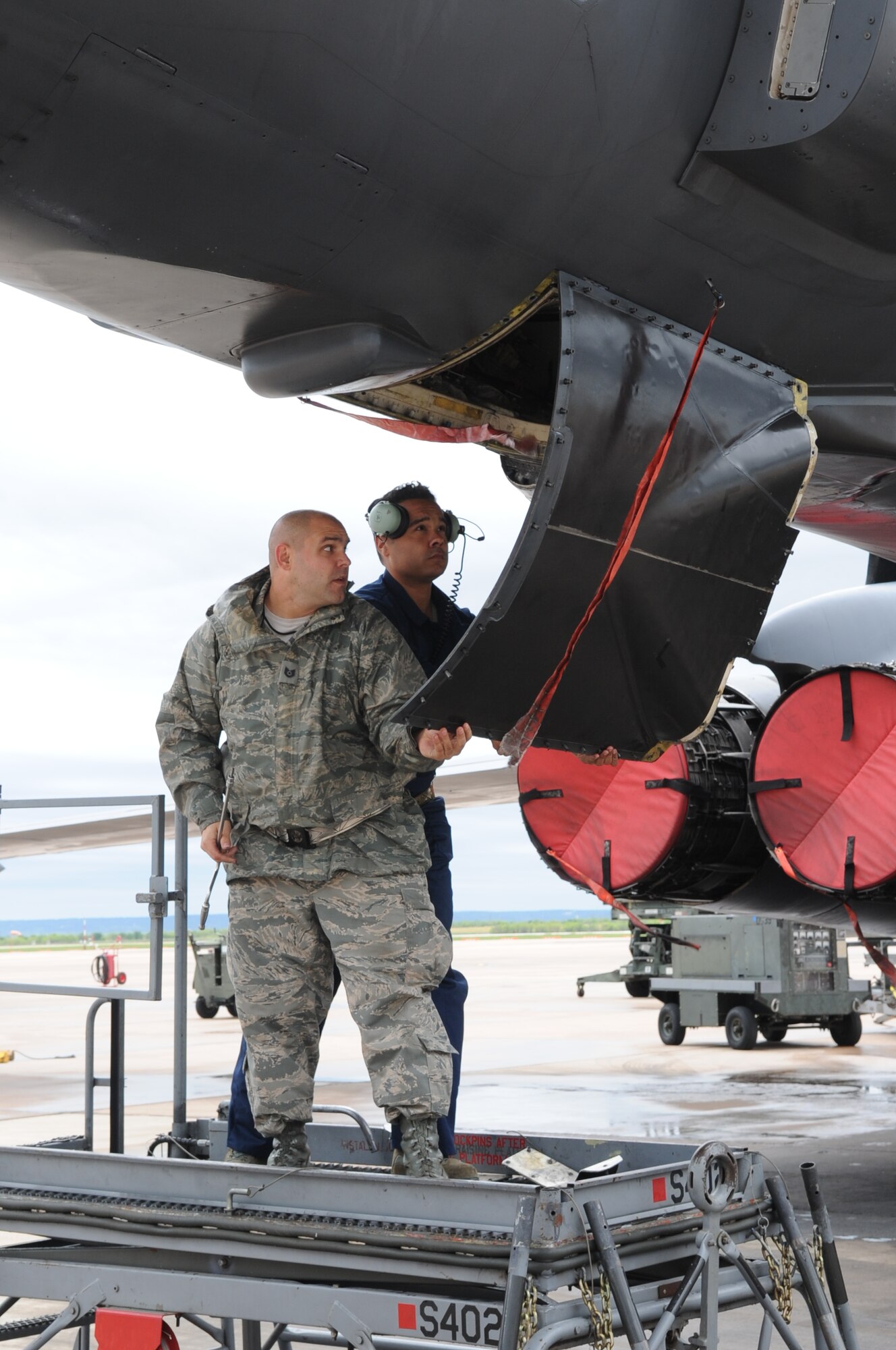 U.S. Air Force Tech. Sgt. Ross Perry, 7th Aircraft Maintenance Squadron electronic warfare noncommissioned officer in charge, left, and Airman 1st Class Terrance Boykins, 7th AMXS crew chief, open a panel on a B-1B Lancer during Exercise Constant Vigilance 16 April 9, 2016, at Dyess Air Force Base, Texas. Air Force Global Strike Command conducts exercises to ensure Airmen are ready to perform nuclear deterrence operations and deliver long-range strike missiles anytime, anywhere. (U.S. Air Force photo by Senior Airman Shannon Hall/Released)