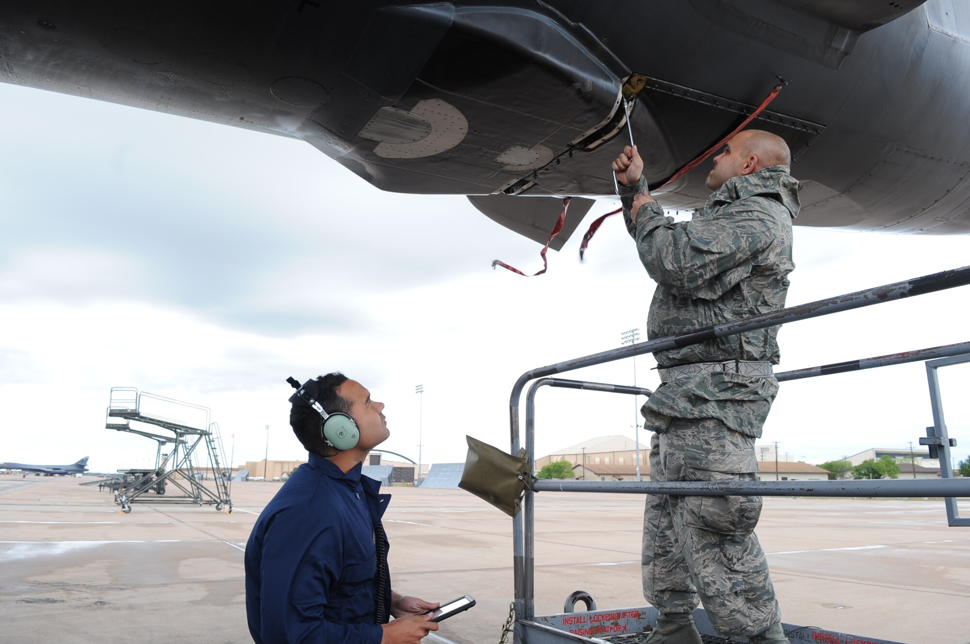 U.S. Air Force Airman 1st Class Terrance Boykins, 7th Aircraft Maintenance Squadron crew chief, left, and Tech. Sgt. Ross Perry, 7th AMXS electronic warfare noncommissioned officer in charge, remove panels from a B-1B Lancer April 9, 2016, at Dyess Air Force Base, Texas. Air Force Global Strike Command conducted Exercise Constant Vigilance 16 to test the command’s ability to support its conventional and nuclear missions. (U.S. Air Force photo by Senior Airman Shannon Hall/Released)
