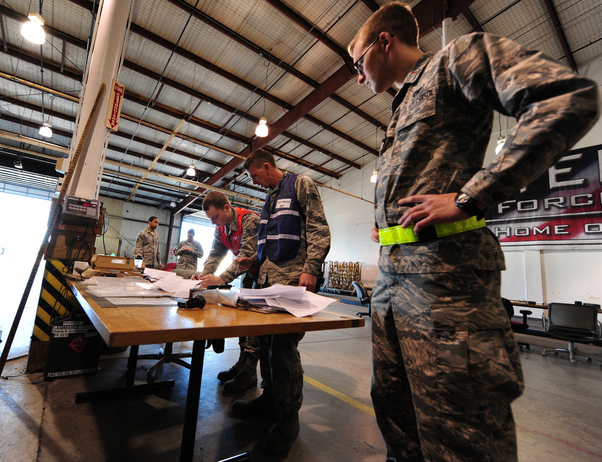 U.S. Air Force 2nd Lt. Alexander Clawson, a 509th Logistics Readiness Squadron (LRS) asset management specialist, left, Staff Sgt. Chris Taylor, the 509th LRS NCO in charge of deployment operations, center, and Airman 1st Class Brandon Tincher, a 509th Logistics Readiness Squadron materiel management specialist, examine cargo documentation during the CONSTANT VIGILANCE 16 exercise at Whiteman Air Force Base, Mo., April 12, 2016. Training and exercise are critical to Air Force Global Strike Command’s ability to respond quickly and effectively to real-world situations. (U.S. Air Force photo by Airman 1st Class Keenan Berry)
