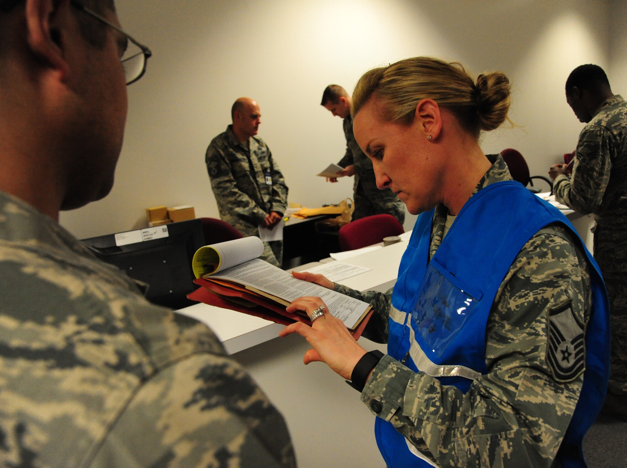 U.S. Air Force Master Sgt. Misty Moreno, 509th Force Support Squadron section chief management, reviews a member’s deployment documents during CONSTANT VIGILANCE 16 at Whiteman Air Force Base, Mo., April 12, 2016. Whiteman participates in training operations and exercises on a constant basis to ensure force readiness to perform nuclear deterrence operations and long-range strike missions when called upon. (U.S. Air Force photo by Airman 1st Class Keenan Berry)