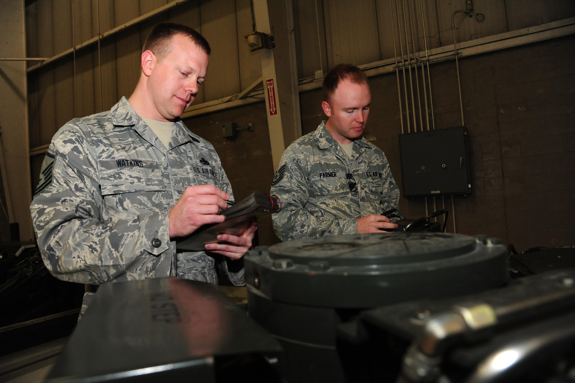 U.S. Air Force Master Sgt. Caleb Watkins, left, and Tech. Sgt. Jaime Farmer, both aircraft armament systems technicians assigned to the 131st Aircraft Maintenance Squadron (AMXS), prep a munitions handling unit (MHU)-204 trailer for loading procedures at Whiteman Air Force Base, Mo., April 14, 2016, Watkins and Farmer are two of three 131st AMXS drill-status guardsmen who loaded weapons to the B-2 Spirit during an exercise for the time during CONSTANT VIGILANCE 16. (U.S. Air Force photo by Airman 1st Class Keenan Berry)