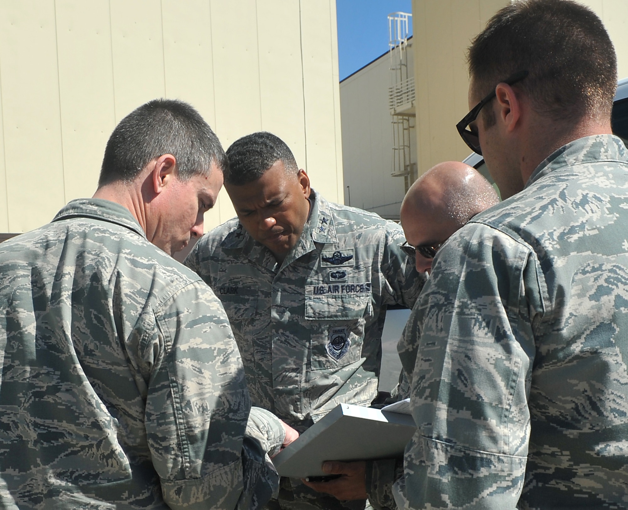 Maj. Gen. Richard M. Clark, 8th Air Force commander, center, discusses aircrew tactics, techniques and procedures with Brig. Gen. Paul W. Tibbets IV, 509th Bomb Wing (BW) commander, left, and other members of the 509th BW at Whiteman Air Force Base, Mo., April 12, 2016. Clark visited Whiteman to observe operations during the CONSTANT VIGILANCE 16 exercise. (U.S. Air Force photo by Airman 1st Class Michaela Slanchik) 