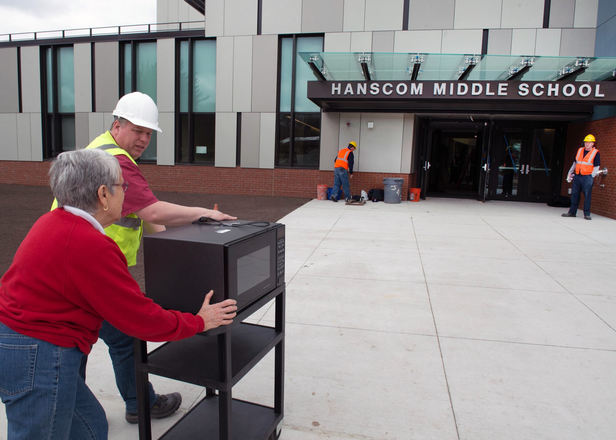 Eric Ledebuhr, Hanscom Middle School principal, and Phyllis Custance, HMS administrative secretary, move into the new middle school on base April 19. While students are on vacation, faculty and staff are moving from the temporary middle school to the new school that opens April 26 for classes. An HMS Open House is scheduled May 2 from 3 to 6 p.m. for all members of the Hanscom community interested in touring the new school. (U.S. Air Force photo by Jerry Saslav)