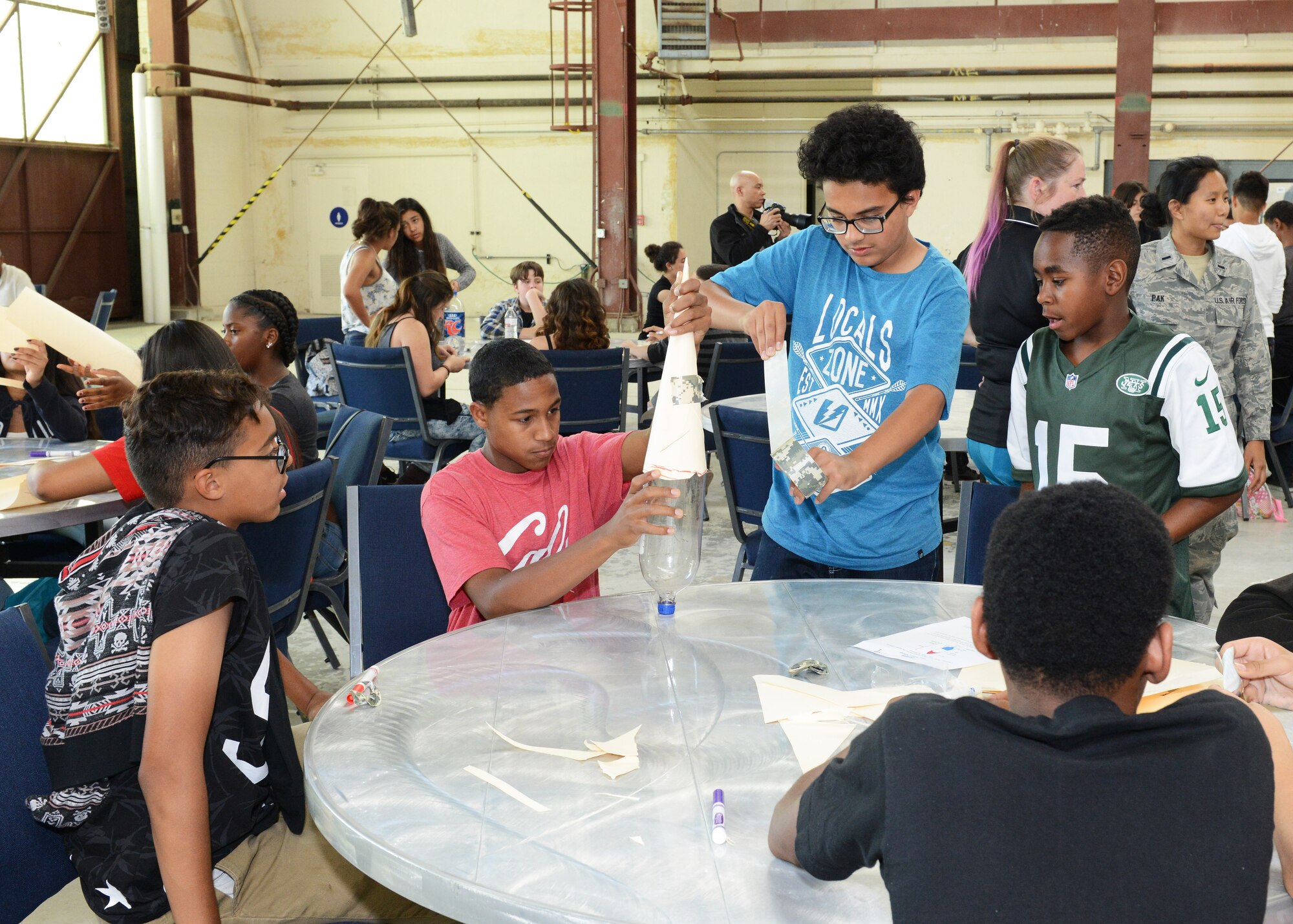 Students from Discovery School in Lancaster broke into teams to build a rocket out of a soda bottle, manila folders and tape during the hands-on portion of their tour to the Air Force Research Laboratory's Propulsion Directorate here at Edwards AFB April 19. The students then got to launch their rockets. (U.S. Air Force photo by Kenji Thuloweit)