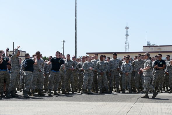 Members of the 374th Aircraft Maintenance Squadron cheer when hearing of their victory during a portion of the 374th Maintenance Group Rodeo Competition at Yokota Air Base, Japan, April 15, 2016. The final task required the participating teams consisting of 20 members to pull a C-130 Hercules with a rope. The winning team was rewarded with points that go toward the Spirit Award, an internal award given to the overall rodeo winner. (U.S. Air Force photo by Staff Sgt. Cody H. Ramirez/Released