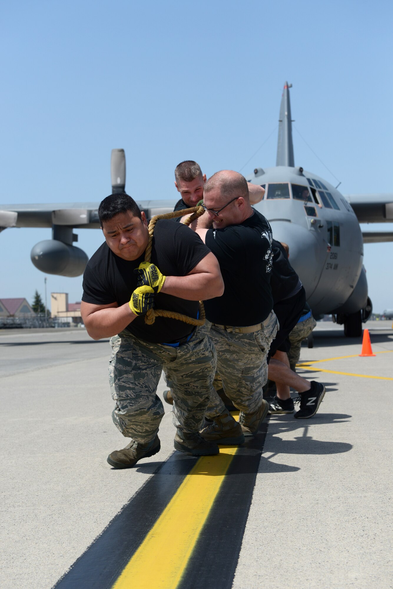 Members of the 374th Maintenance Operations Flight pull a C-130 Hercules at Yokota Air Base, Japan, April 15, 2016. The 374 MOF won the C-130 pull, gaining points toward the Spirit Award, an internal award given to the squadron who scores the most points during the rodeo (U.S. Air Force photo by Staff Sgt. Cody H. Ramirez/Released)