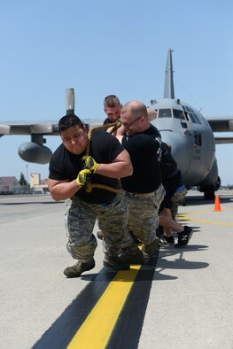 Members of the 374th Aircraft Maintenance Squadron pull a C-130 Hercules at Yokota Air Base, Japan, April 15, 2016. The 374 AMXS won the C-130 pull, gaining points toward the Spirit Award, an internal award given to the squadron who scores the most points during the rodeo (U.S. Air Force photo by Staff Sgt. Cody H. Ramirez/Released)
