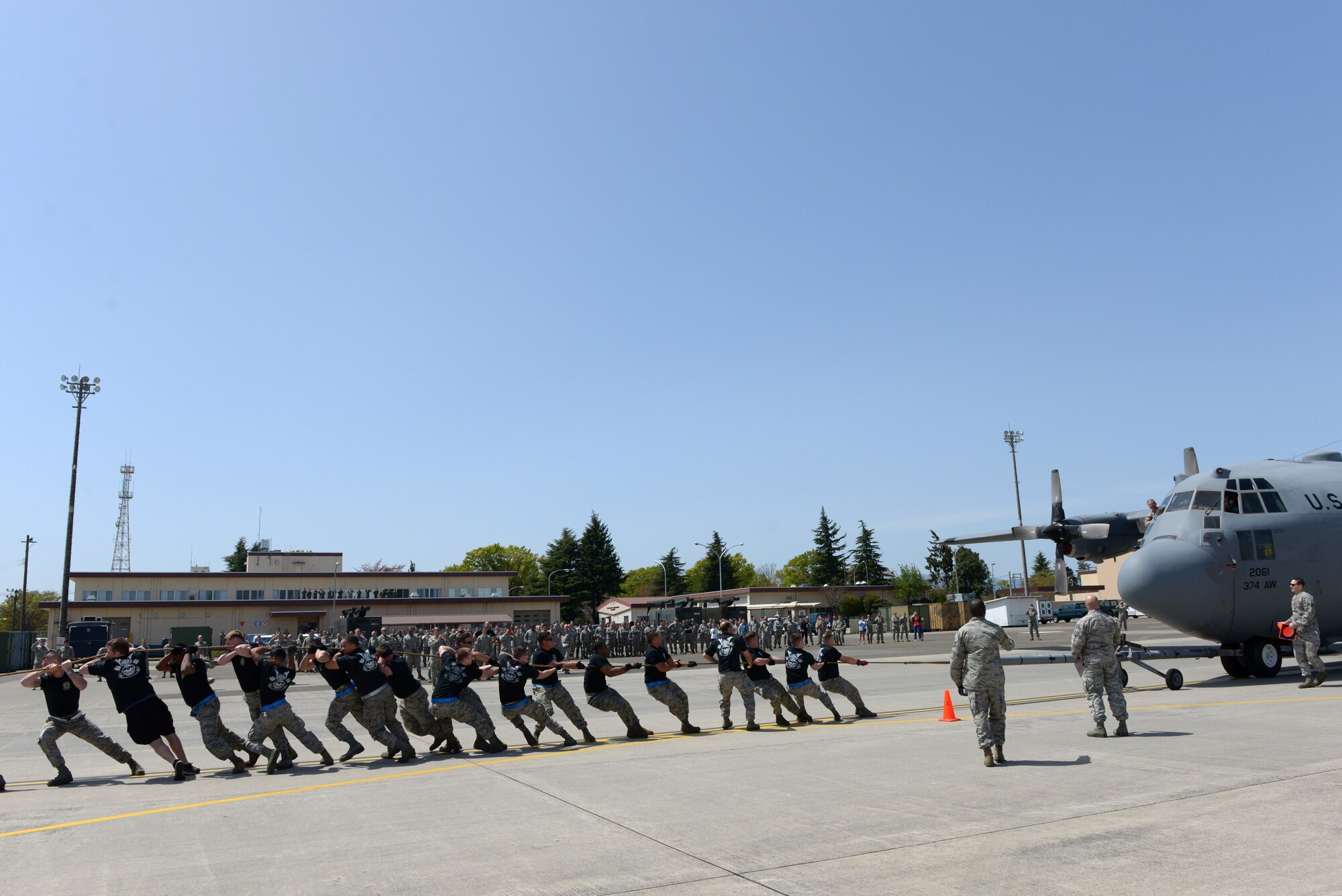 Members of the 374th Maintenance Operations Flight pull a C-130 Hercules at Yokota Air Base, Japan, April 15, 2016. The 374 MOF won the C-130 pull challenge, gaining points toward the Spirit Award, the overall prize for winning the rodeo. (U.S. Air Force photo by Staff Sgt. Cody H. Ramirez/Released)