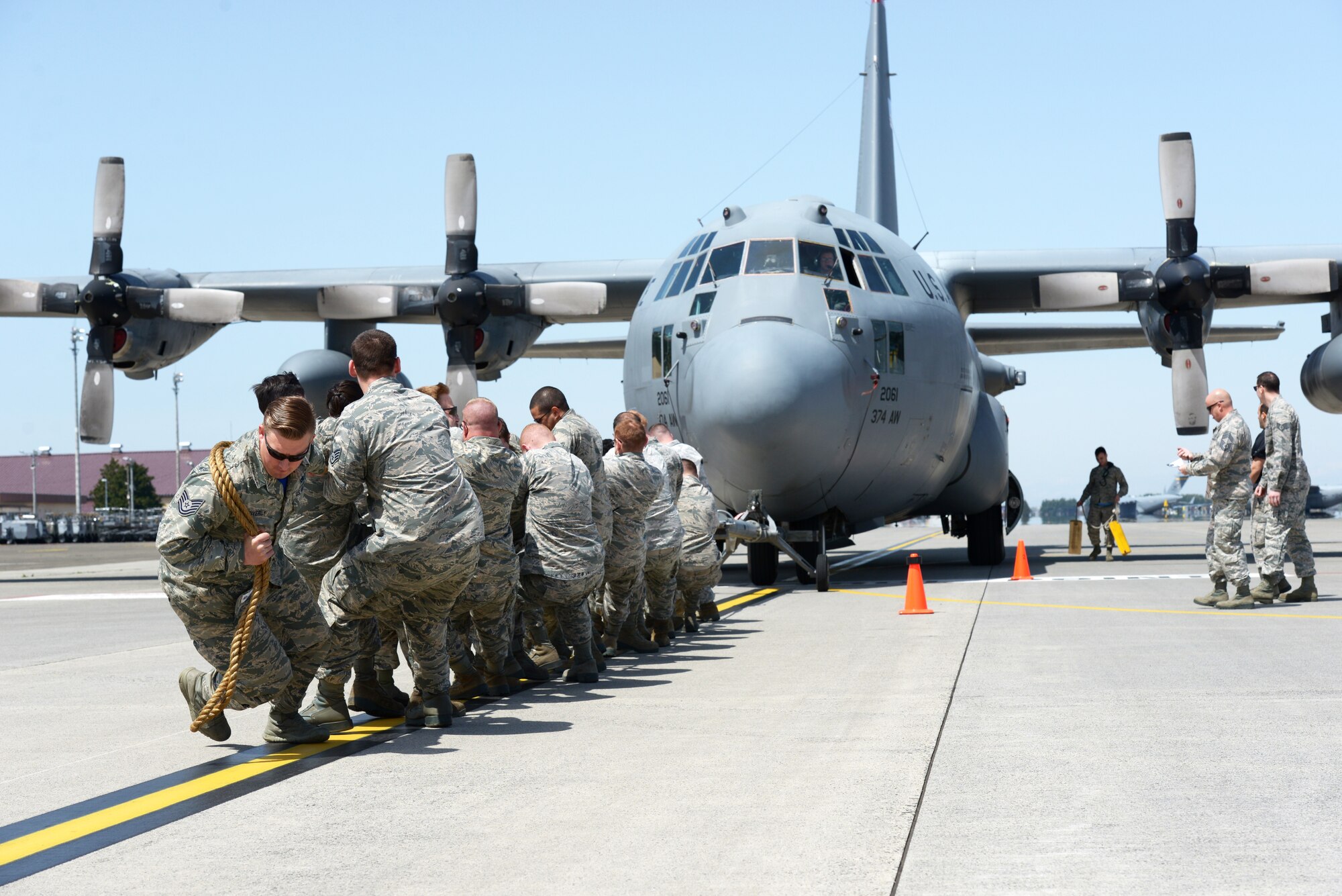 Members with the 374th Maintenance Squadron pull a C-130 Hercules at Yokota Air Base, Japan, April 15, 2016. The aircraft was pulled as part of the 374th Maintenance Group Maintenance Rodeo Competition which puts squadrons against each other in various tasks to win points toward an award and a year’s worth of bragging rights. (U.S. Air Force photo by Staff Sgt. Cody H. Ramirez/Released)