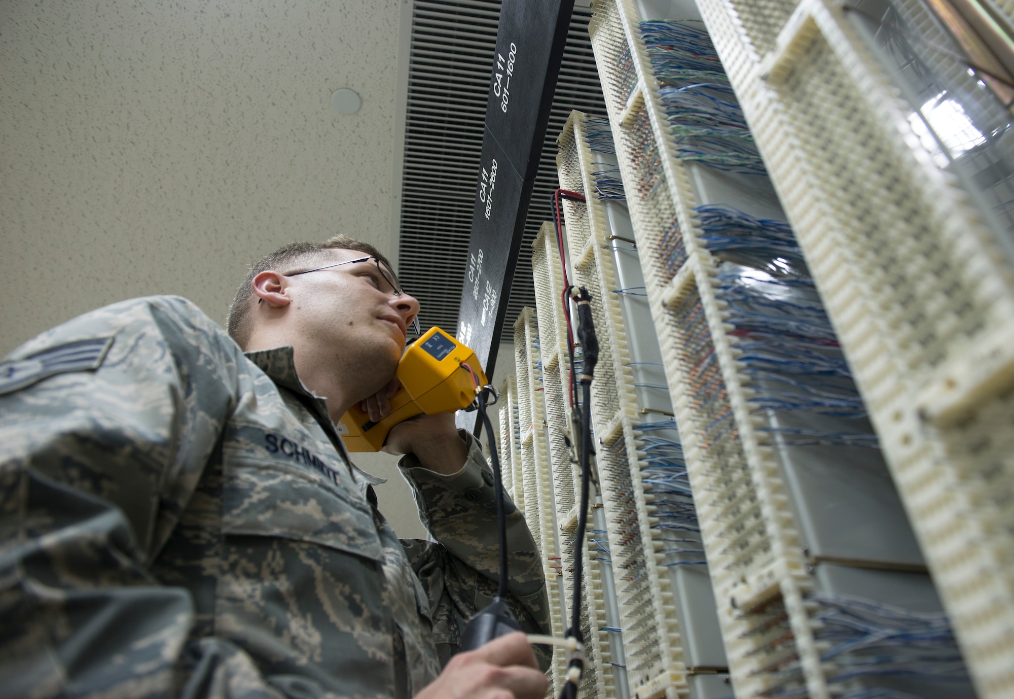 U.S. Air Force Staff Sgt. Damon Schmidt, 18th Communications Squadron cyber transport supervisor checks for a dial tone on the Kadena telephone switch April 20, 2016, at Kadena Air Base, Japan. Kadena’s Defense Switched Network End-Office continues to support multiple installations on Okinawa and strives for customer satisfaction. (U.S. Air Force photo by Senior Airman Omari Bernard)