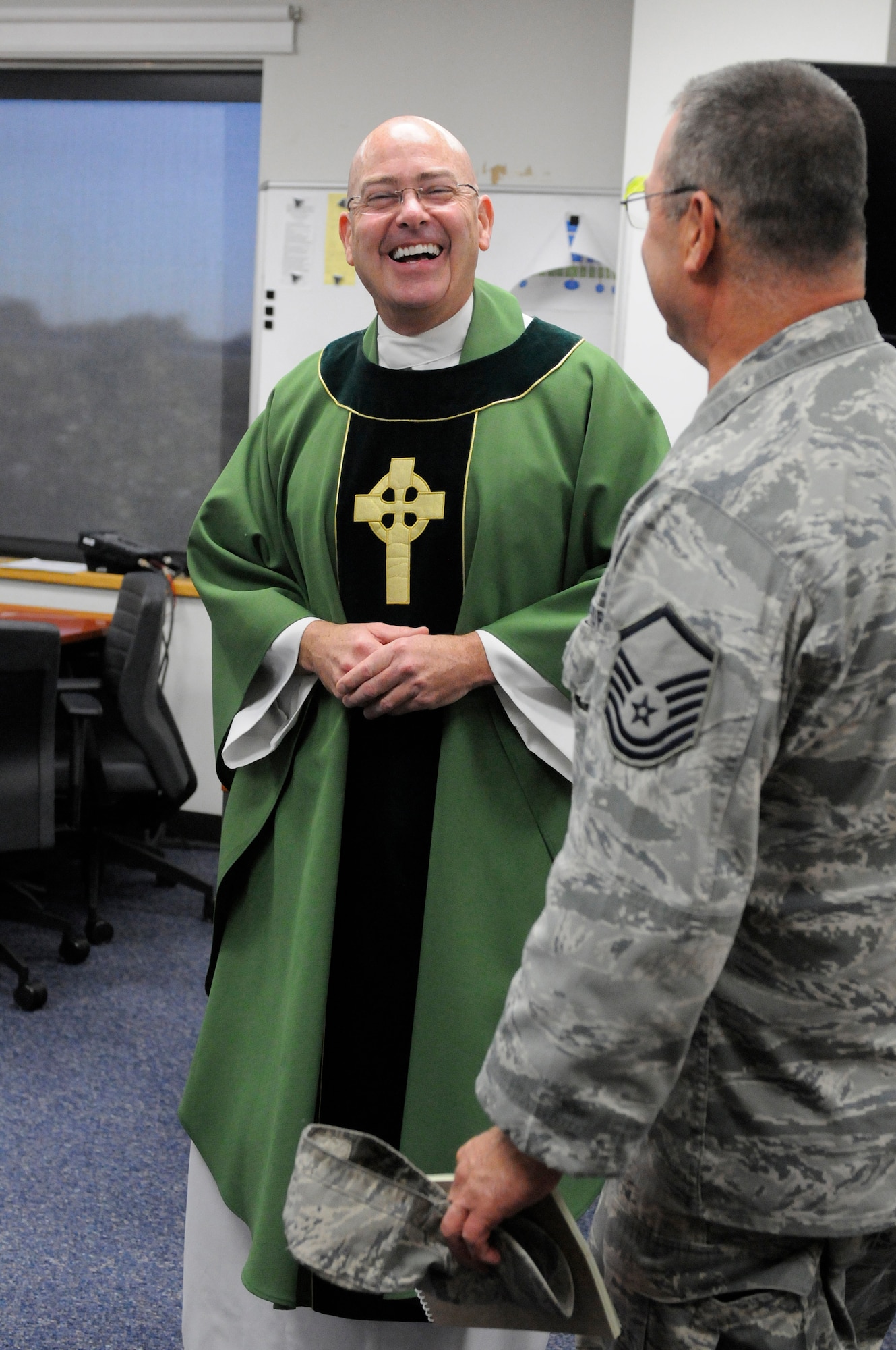 The newest chaplain at the 123rd Airlift Wing, Capt. Jeffrey Nicolas, speaks with an Airman following Catholic Mass at the Kentucky Air National Guard Base in Louisville, Ky., Oct. 18, 2015. Nicolas previously served as a chaplain in the U.S. Navy. (U.S. Air National Guard photo by Tech. Sgt. Vicky Spesard)