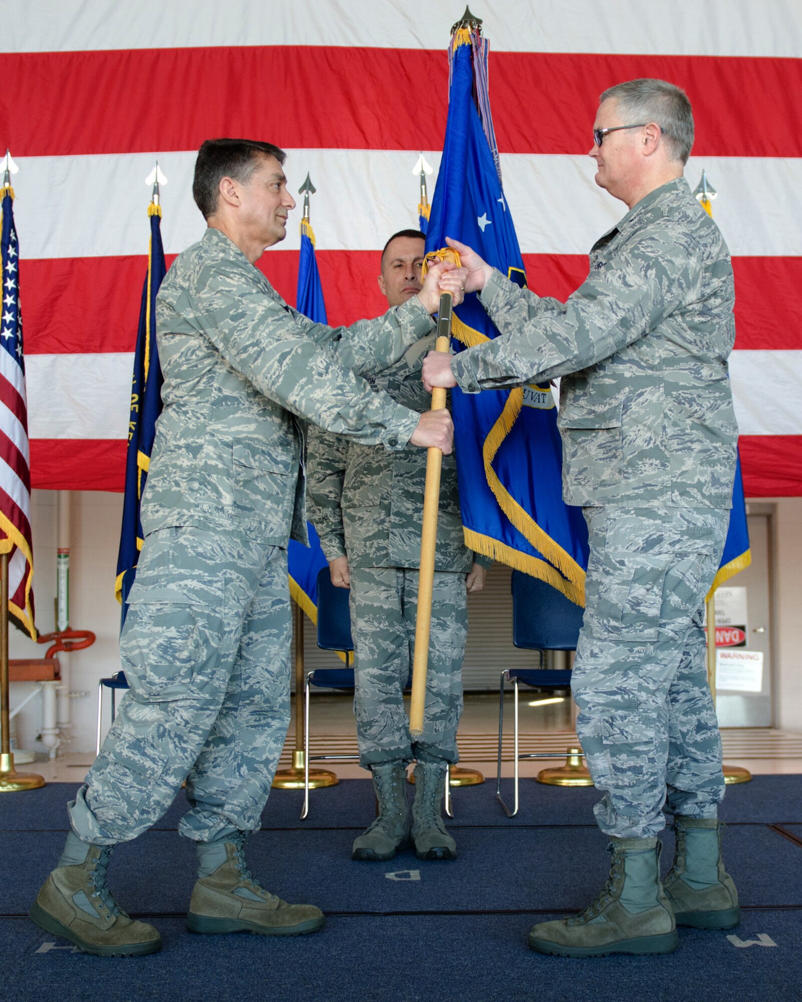 Col. David Mounkes (right), the new commander of the 123rd Airlift wing, accepts the wing guidon from Brig. Gen. Warren Hurst, Kentucky’s assistant adjutant general for Air, during an assumption-of-command ceremony at the Kentucky Air National Guard Base in Louisville, Ky., on April 16, 2016. Mounkes most recently served as commander of the 123rd Contingency Response Group. (U.S. Air National Guard photo by Senior Airman Joshua Horton)