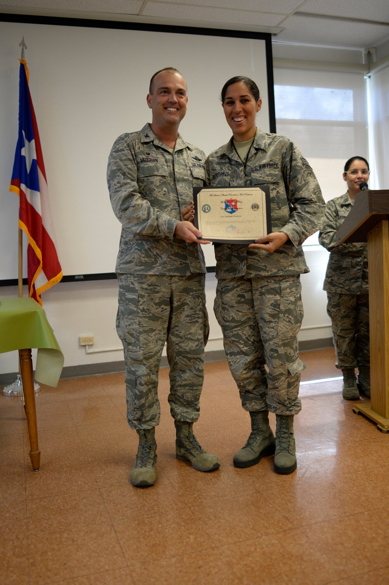 U.S. Air Force Senior Airman Aurimar Guiterrez of the 156th Airlift Wing receives recognition from the 156th AW Commander, Col. Edward L. Vaughan, for her volunteer efforts and support of the Sexual Assault Prevention and Response Program during an appreciation breakfast held at Muñiz Air National Guard Base, Carolina, Puerto Rico, April 14. (U.S. Air National Guard photo by Staff Sgt. Christian Jadot)