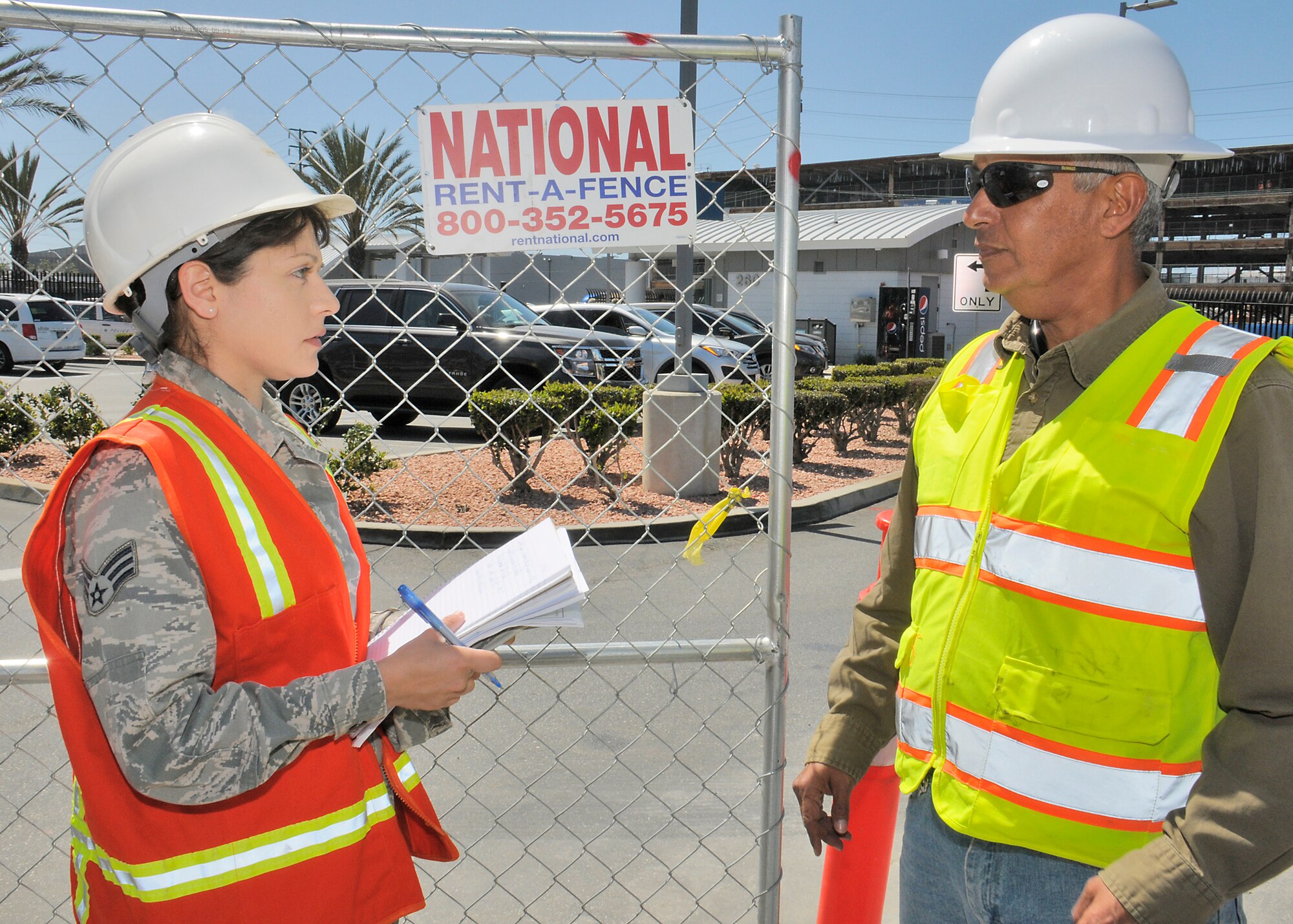 Senior Airman Gladys Pargas talks to the project manger overseeing Douglas Street upgrades. (U.S Air Force photo/Joe Juarez)
