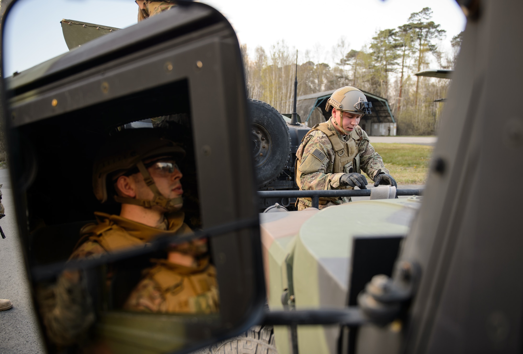 A member of the 435th Contingency Response Group watches as a fellow Airman prepares to tow a “broken down” Humvee at Ramstein Air Base, Germany, April 11, 2016. In preparation for a deployment Airmen practiced a variety of scenarios they might encounter during a mission to build up a bare base. (U.S. Air Force photo/Staff Sgt. Armando A. Schwier-Morales)