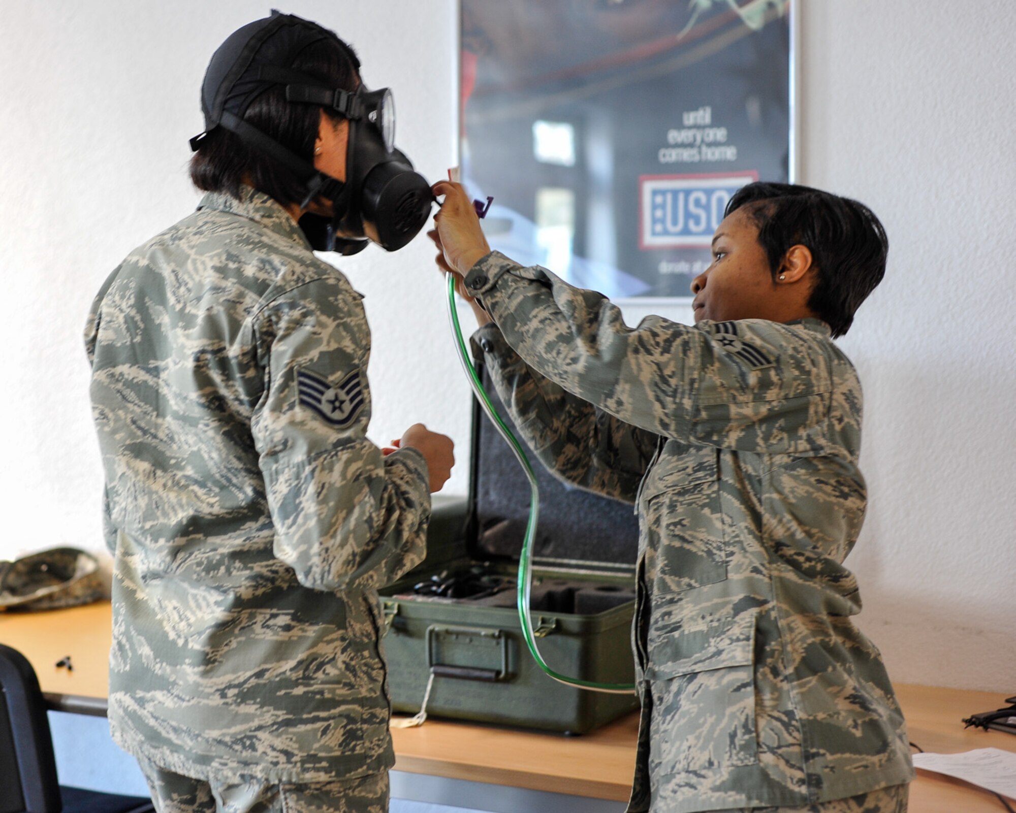 Staff Sgt. Kellye Marshall, 86th Medical Group commander’s support section, receives a gas-mask fit test from Senior Airman Alexis Gilliam, 86th Bioenvironmental engineering technician during  Wing Thunder April 20, at Ramstein Air Base, Germany. Gas-mask fit tests are conducted in addition to the member receiving all their individual protective equipment. (U.S. Air Force photo/Staff Sgt. Leslie Keopka)