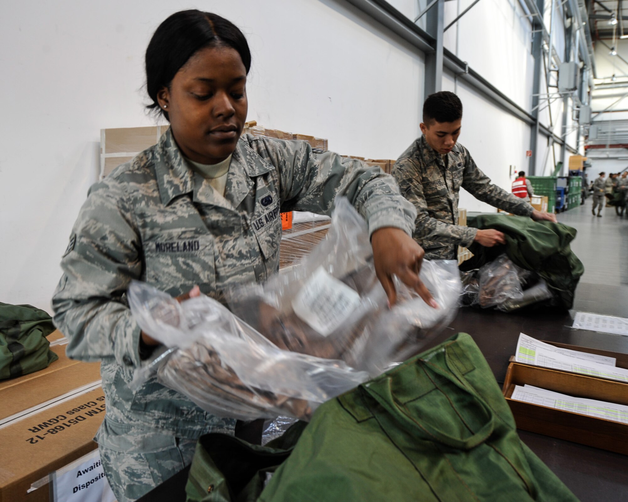 Senior Airman LaMicah Moreland, 86th Logistic Readiness Squadron individual protective equipment journeyman, performs a quality control check on an Airman’s issued gear during Wing Thunder April 20, at Ramstein Air Base. Moreland is one of many quality control personnel ensuring all participants are issued the correct gear and sizes. Wing Thunder is an inspection designed to exercise the 86th Airlift Wing’s readiness and operational capabilities through objective-driven scenarios. (U.S. Air Force photo/Staff Sgt. Leslie Keopka)