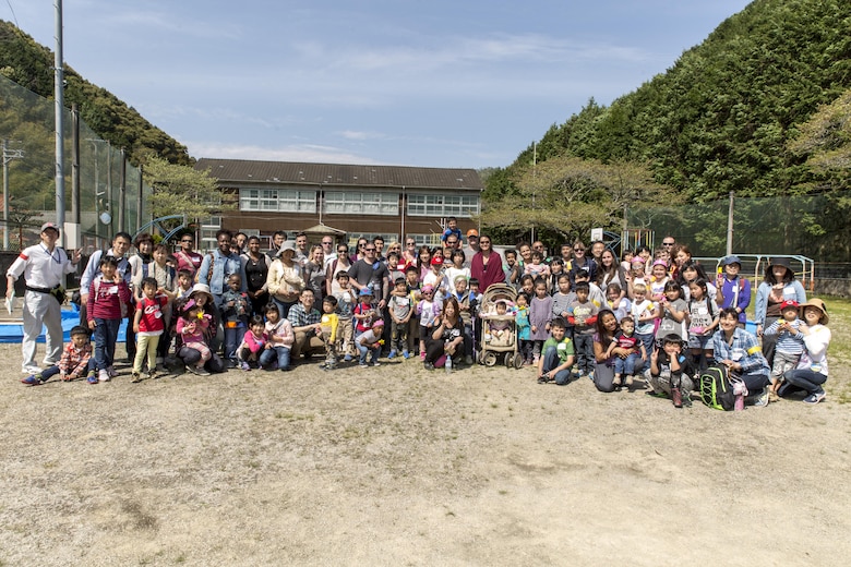 Residents from Marine Corps Air Station Iwakuni pose with Japanese civilians and volunteers for a group photo during a Mochitsuki – rice pounding – event at Tenno Elementary School in Tenno, Japan, April 16, 2016. The event offered residents the opportunity to interact with Japanese civilians and experience a different part of their culture. (U.S. Marine Corps photo by Lance Cpl. Aaron Henson/Released)