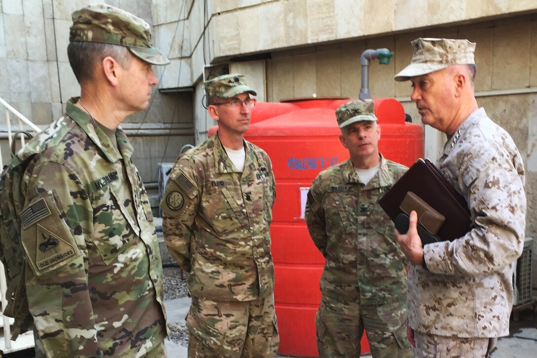 Marine Corps Gen. Joe Dunford, chairman of the Joint Chiefs of Staff,  speaks with Army Col. Steve Warren, second from right, Army Lt. Col. Charles Floyd and Army Lt. Gen. Sean MacFarland, left,  in Baghdad, April 21, 2016. Dunford is visiting Iraq to assess the campaign against the Islamic State of Iraq and the Levant. DoD photo by Jim Garamone