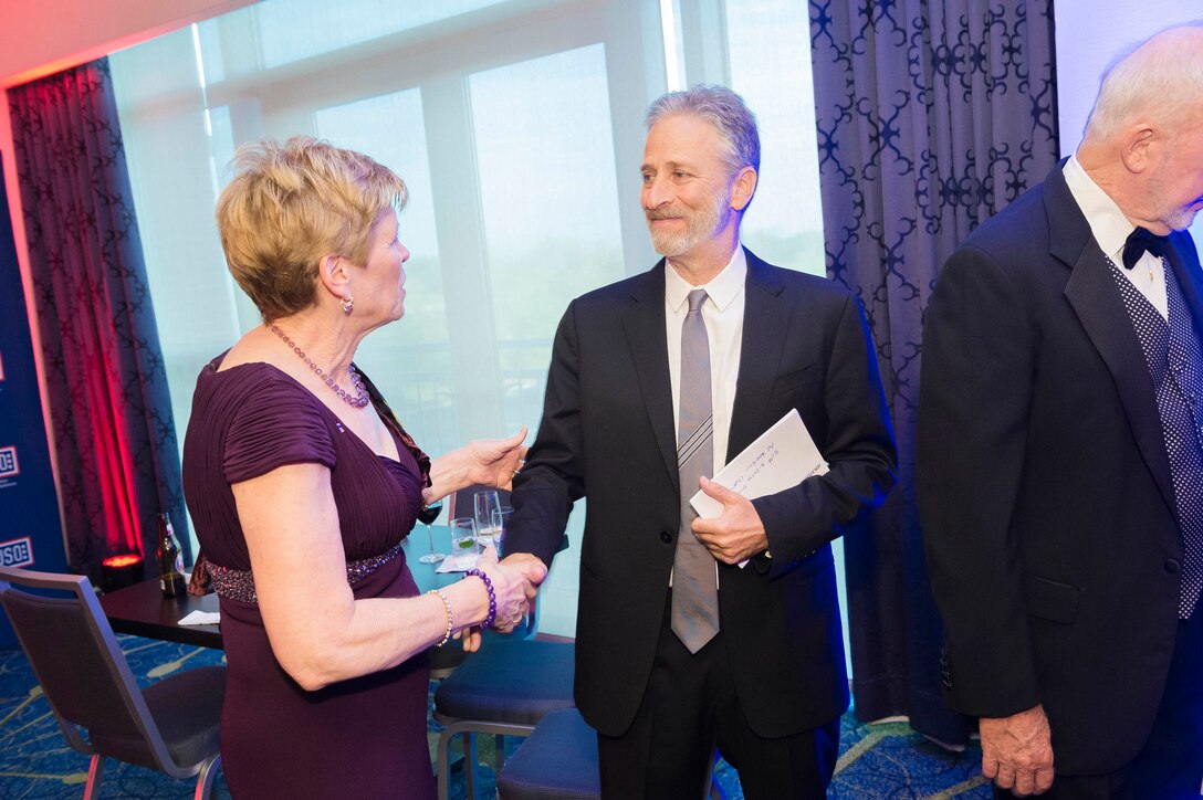 Ellyn Dunford, wife of Marine Gen. Joseph F. Dunford, chairman of the Joint Chiefs of Staff, meets former Daily Show host Jon Stewart during the USO Metropolitan Washington-Baltimore annual awards dinner, in Arlington, Va., April 19, 2016.  DoD photo by Army Staff Sgt. Sean K. Harp
