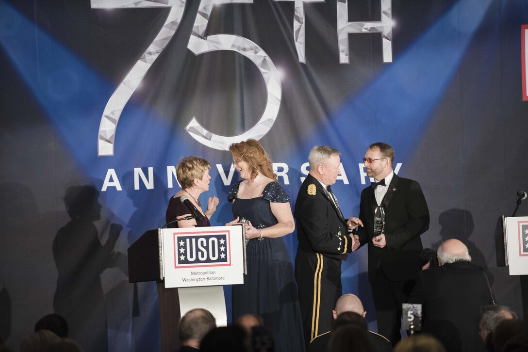 Ellyn Dunford; wife of U.S. Marine Gen. Joseph F. Dunford Jr., chairman of the Joint Chiefs of Staff, and Gen. Frank J. Grass, Chief of the National Guard Bureau, present Melissa and Sgt. 1st Class Jon Meadows with the USO Metropolitan Washington-Baltimore's Colonel John Gioia Patriot Award during the USO Metropolitan Washington-Baltimore annual awards dinner, in Arlington, Va., April 19, 2016. During the event, which highlighted their 75th anniversary, the USO honored the service and sacrifice of the U.S. Armed Forces and featured a tribute to special operations forces.  DoD photo by Army Staff Sgt. Sean K. Harp