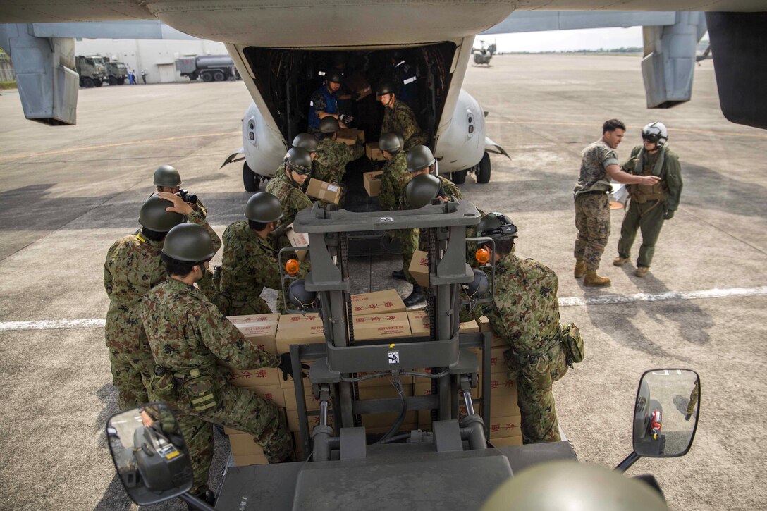 Japanese soldiers load relief supplies onto an MV-22B Osprey aircraft at Japanese Camp Takayubaru near the Aso-Kumamoto airport, Japan, April 20, 2016. Marine Corps photo by Sgt. Royce Dorman 