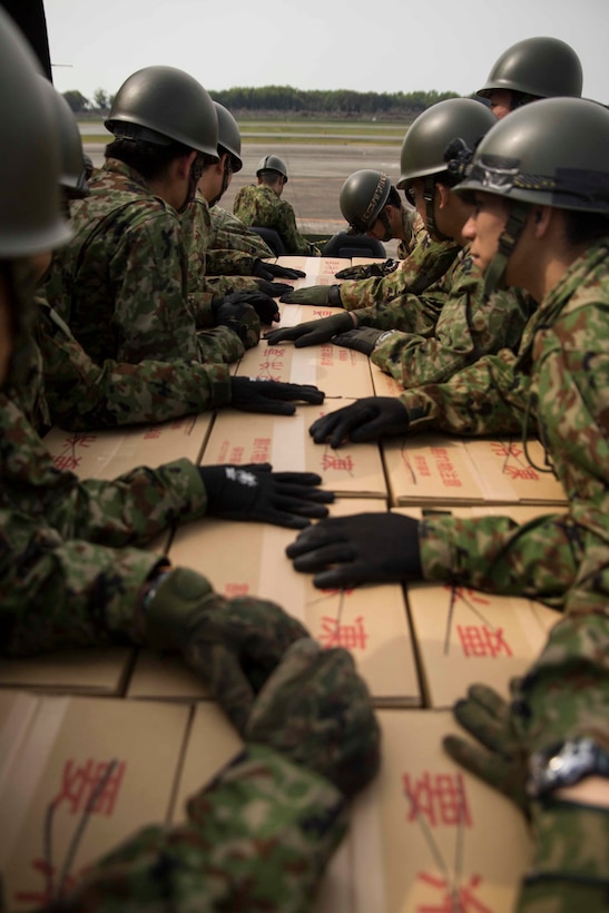 Japanese soldiers load relief supplies onto an MV-22B Osprey aircraft at Japanese Camp Takayubaru near the Aso-Kumamoto airport, Japan, April 20, 2016. Marine Corps photo by Sgt. Royce Dorman 