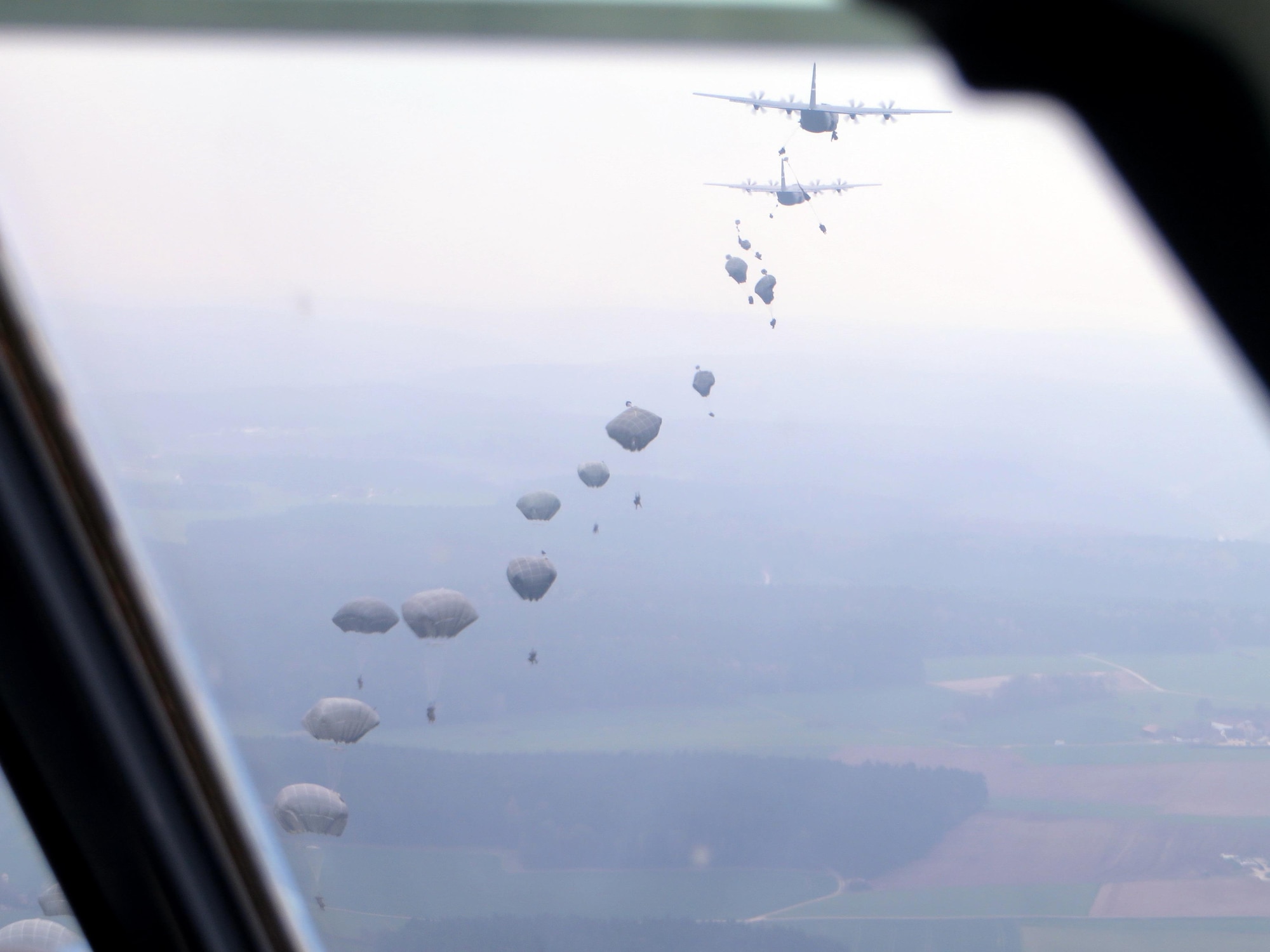 C-130s release paratroopers from the U.S. Army 173rd Airborne Brigade over Hohenfels, Germany during exercise Saber Junction 16, April 12, 2016. The Air Force Reserve’s 815th Airlift Squadron participated in the exercise April 5-20, 2016. (U.S. Air Force photo/Maj. Dave Hogue)