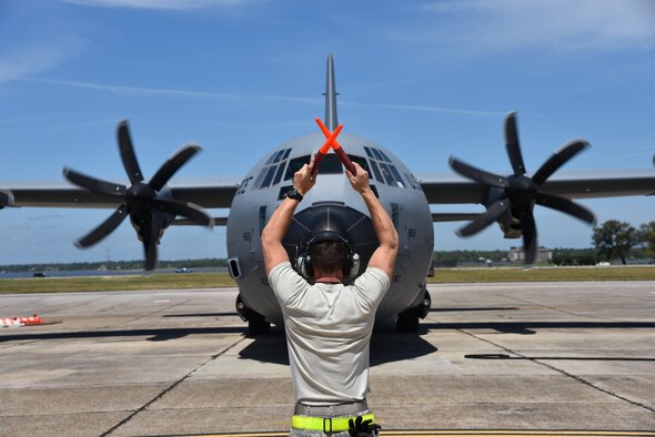 Senior Airman Christopher Townsley, 403rd Aircraft Maintenance Squadron crewchief at Keesler Air Force Base, Mississippi, marshalls in an 815th Airlift Squadron aircrew returning from Saber Junction 16, April 20, 2016. The exercise, which started March 31 and ends April 24, is the U.S. Army’s annual combat training center certification exercise to evaluate the readiness of the 173rd Airborne Brigade. The 815th AS participated in the training event April 5-20, 2016. (U.S. Air Force/Maj. Marnee Losurdo)