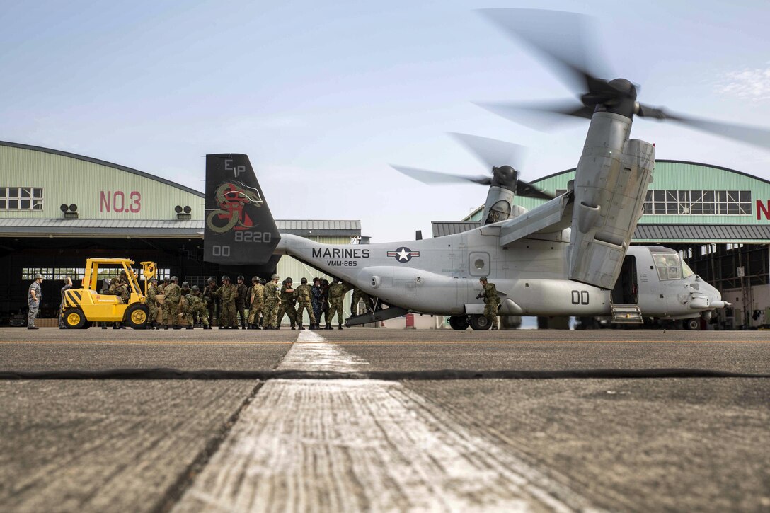 Japanese soldiers load relief supplies onto an MV-22B Osprey aircraft at Japanese Camp Takayubaru near the Aso-Kumamoto airport, Japan, April 20, 2016. Marine Corps photo by Sgt. Royce Dorman