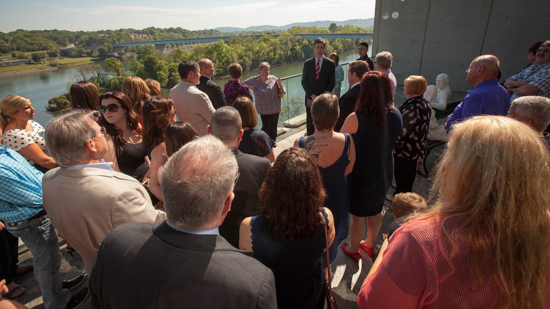 Andy Berke, mayor of Chattanooga, speaks with the families of Gunnery Sgt. Thomas J. Sullivan, Staff Sgt. David Wyatt, Sgt. Carson Holmquist, and Lance Cpl. Squire Wells following the Purple Heart ceremony presentation at the Hunter Museum of American Art in Chattanooga, Tenn. April 20, 2016. The mayor informed the families that the Veterans Bridge is being dedicated to the fallen Marines and a plaque and permanent flags are being added in their honor. 