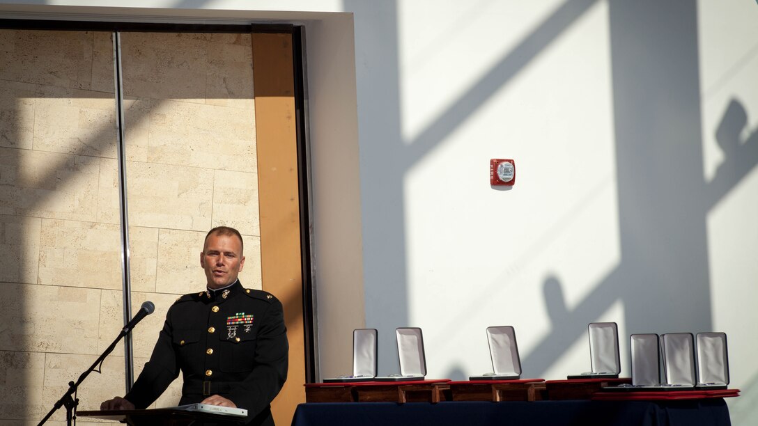 Maj. Christopher Cotton, inspector-instructor, Battery M, 3rd Battalion, 14th Marine Regiment, Marine Forces Reserve speaks during the Purple Heart ceremony held in honor of Gunnery Sgt. Thomas J. Sullivan, Staff Sgt. David Wyatt, Sgt. Carson Holmquist, and Lance Cpl. Squire Wells at the Hunter Museum of American Art in Chattanooga, Tenn., April 20, 2016. The Marines were honored for giving their lives to protect others when they were attacked by a gunman at the Naval Operational Support Center and Marine Corps Reserve Center in Chattanooga on July 16, 2015. 
