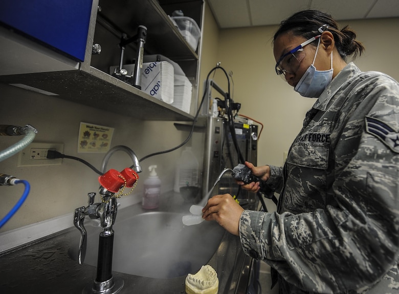Airman 1st Class Christine Chang, a dental laboratory technician with the 1st Special Operations Dental Squadron, uses steam to clean off a mold at Hurlburt Field, Fla., April 18, 2016. The dental laboratory creates mouth appliances for patients prescribed by the dentists. Appliances may be permanent or removable depending on the treatment plan. (U.S. Air Force photo by Senior Airman Meagan Schutter)