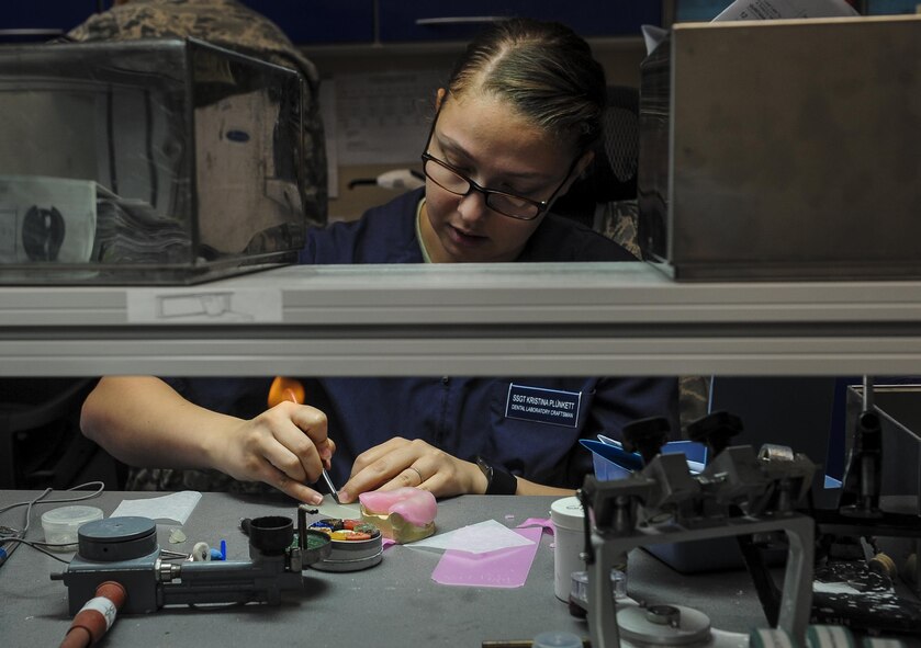 Staff Sgt. Kristina Plunkett, a dental laboratory technician with the 1st Special Operations Dental Squadron, cuts off excess material from a custom tray at Hurlburt Field, Fla., April 18, 2016. This four-manned laboratory cares for more than 40 patients every month. (U.S. Air Force photo by Senior Airman Meagan Schutter)