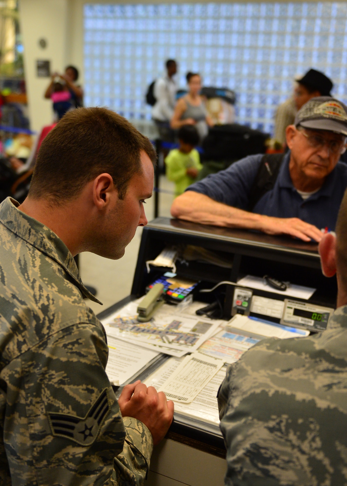 Senior Airman Brice Safreed, an Air Force Reservist from the 32nd Aerial Port Squadron, Pittsburgh Air Reserve Station, helps a customer during boarding on Joint Base Pearl Harbor-Hickam, April 14, 2016. Approximately 30 Airmen from the 32nd APS traveled to JBPHH to conduct annual training hosted by the Airmen of the 735th Air Mobility Squadron. (U.S. Air Force photo by Tech. Sgt. Aaron Oelrich/Released)