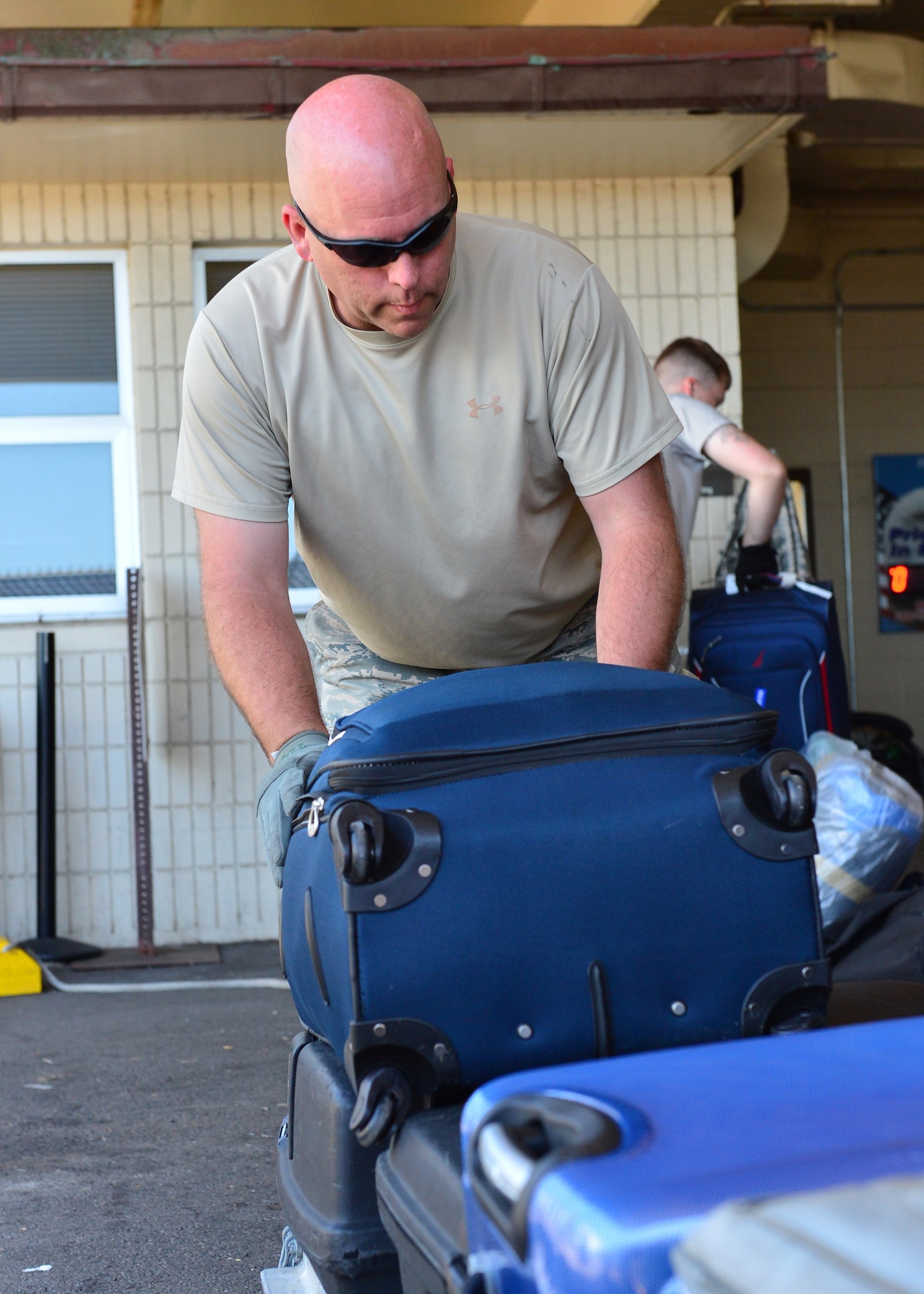 Tech. Sgt. Stevan Hunlick, an Air Force Reservist from the 32nd Aerial Port Squadron, Pittsburgh Air Reserve Station, moves luggage onto a pallet to be loaded on an aircraft on Joint Base Pearl Harbor-Hickam, April 14, 2016. Approximately 30 Airmen from the 32nd APS traveled to JBPHH to conduct annual training hosted by the Airmen of the 735th Air Mobility Squadron. (U.S. Air Force photo by Tech. Sgt. Aaron Oelrich)