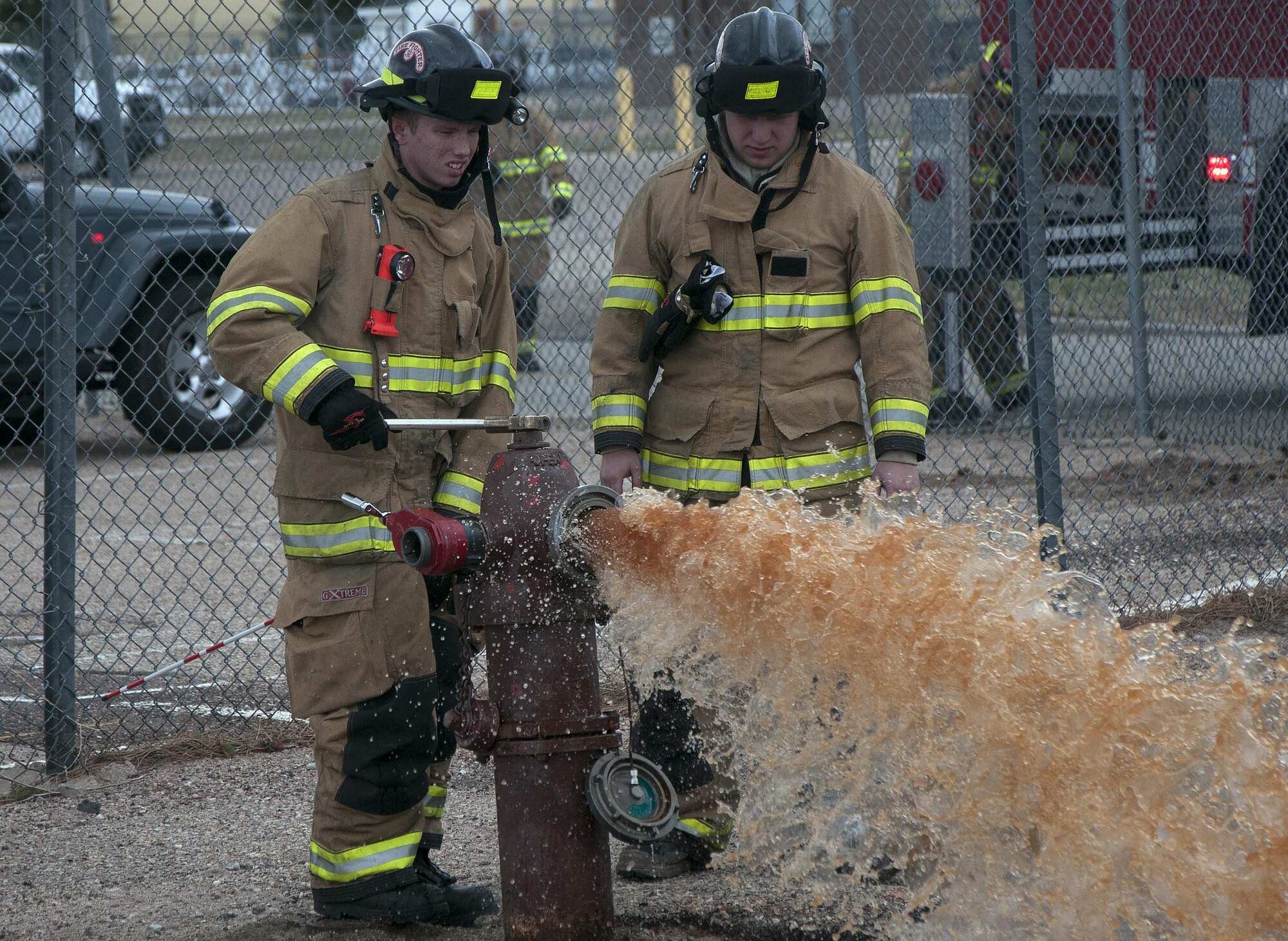Two 90th Civil Engineer Squadron firefighters flush a fire hydrant to clear it before refilling a fire truck April 13, 2016, on F.E. Warren Air Force Base, Wyo. The 90th Missile Wing and Air Force Global Strike Command conduct training operations and exercises on a regular basis to ensure forces are ready to perform emergency response operations. (U.S. Air Force photo by Senior Airman Brandon Valle)