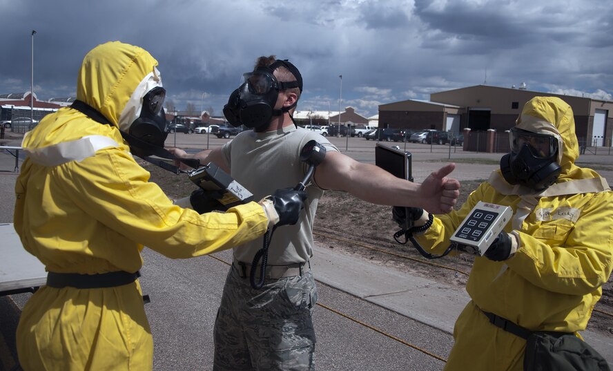 Ninetieth Medical Group Emergency Management Support Team scans an Airman during an exercise on F.E. Warren Air Force Base, Wyo., April 13, 2016. Certain emergency scenes require all departing personnel to be cleared by an EMS team. (U.S. Air Force photo by Senior Airman Brandon Valle)