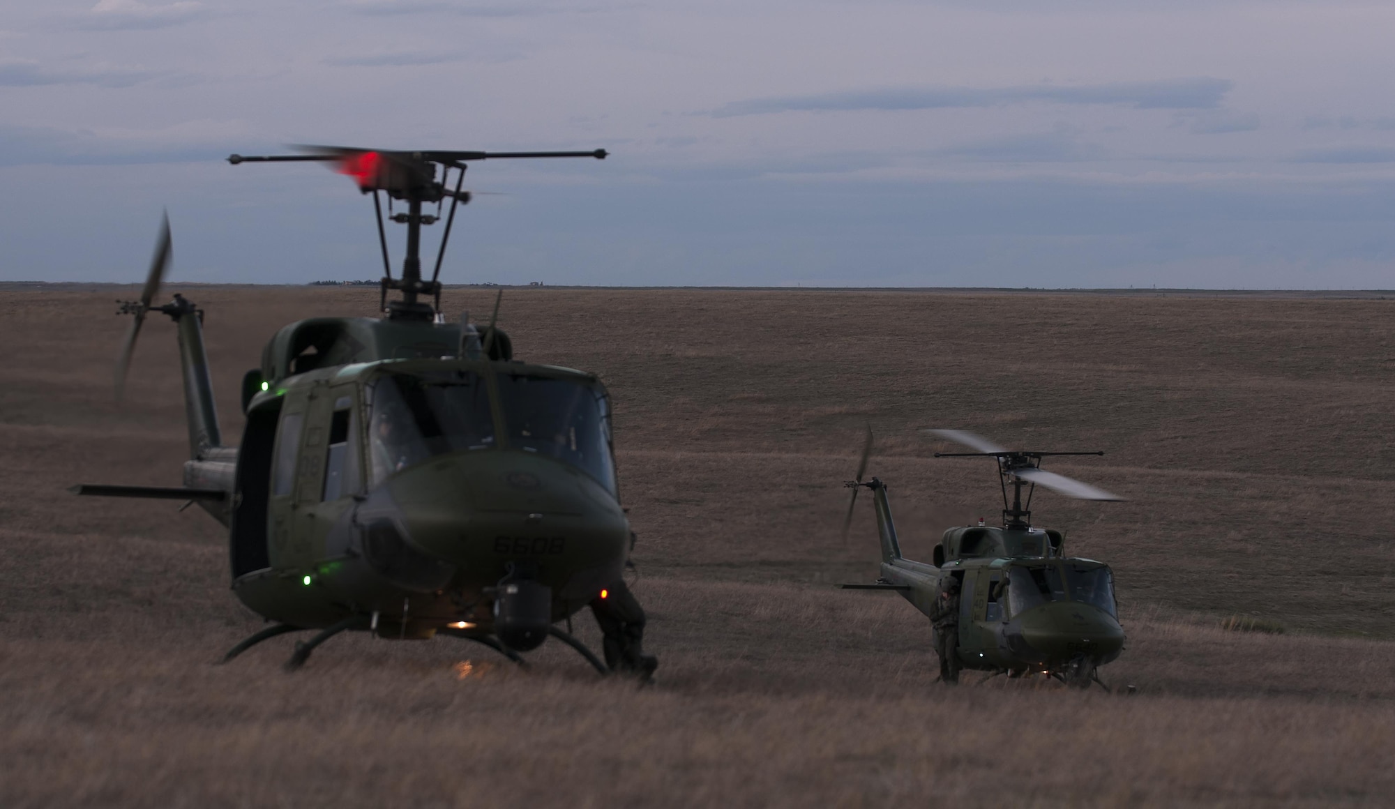 Two 37th Helicopter Squadron UH-1N Bell Helicopters  land outside a launch facility April 14, 2016, during an exercise in the F.E. Warren Air Force Base, Wyo., Missile Complex. The 37th HS supports the mission of the Mighty Ninety by providing aerial surveillance and emergency deployments of security response forces throughout the base and missile field. (U.S. Air Force photo by Senior Airman Brandon Valle)