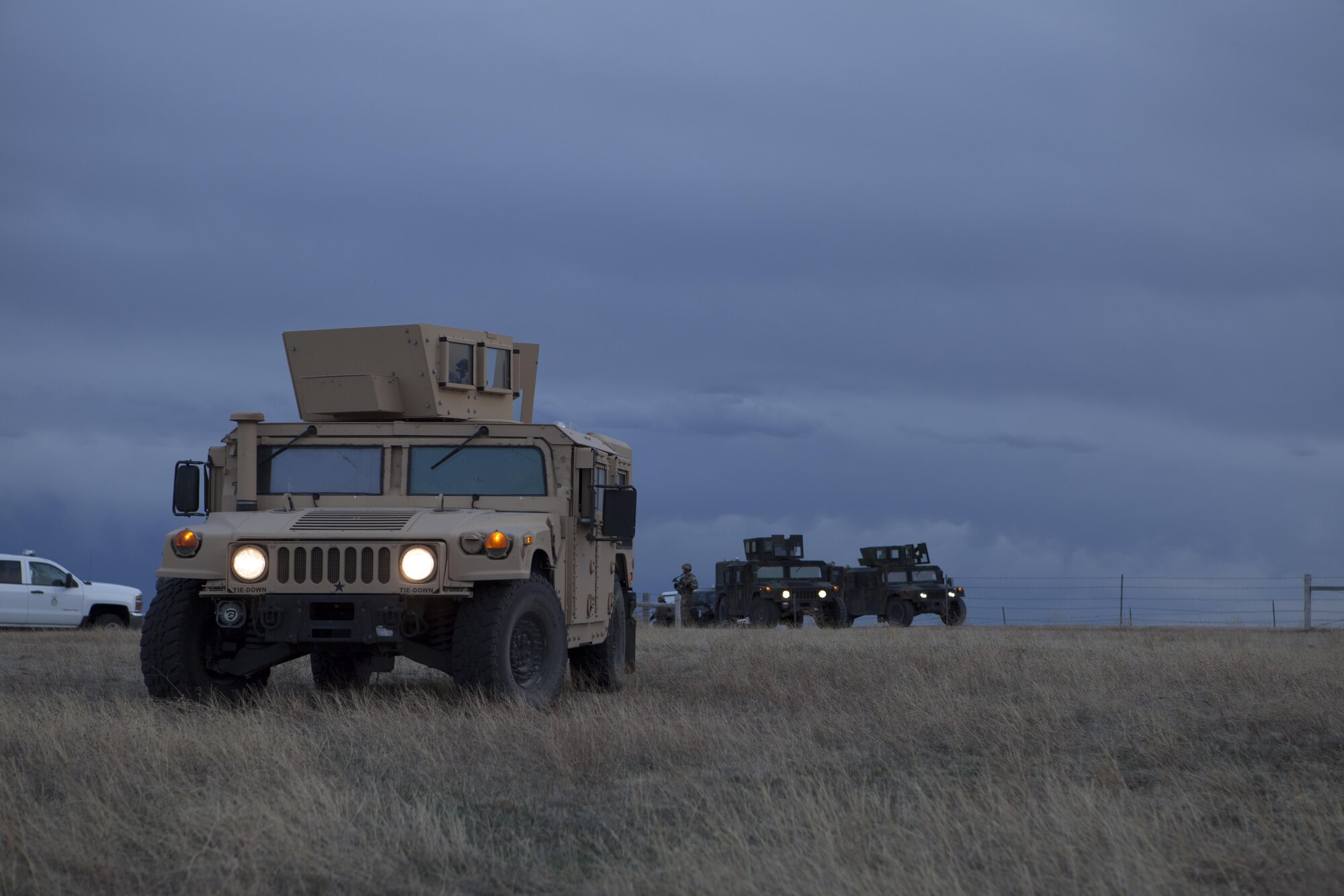 Humvees filled with 90th Security Forces Group defenders sit idle after the completion of an exercise April 14, 2016, in the F.E. Warren Air Force Base, Wyo., Missile Complex. The 90th Missile Wing and Air Force Global Strike Command conduct training operations and exercises on a regular basis to ensure forces are ready to perform response operations. (U.S. Air Force Photo by Lan Kim)