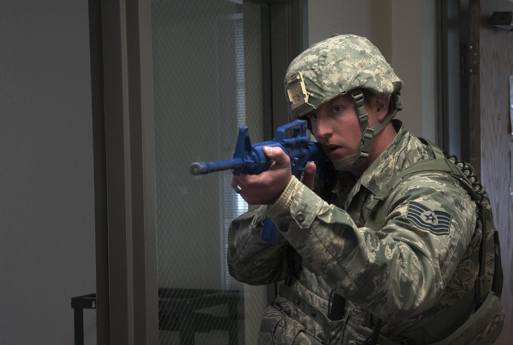 A 90th Security Forces Group technical sergeant keeps watch down a hallway during an active shooter exercise April 15, 2016, on F.E. Warren Air Force Base, Wyo. The 90th Missile Wing and Air Force Global Strike Command conduct training operations and exercises on a regular basis to ensure forces are ready to perform emergency response operations. (U.S. Air Force photo by Senior Airman Brandon Valle)
