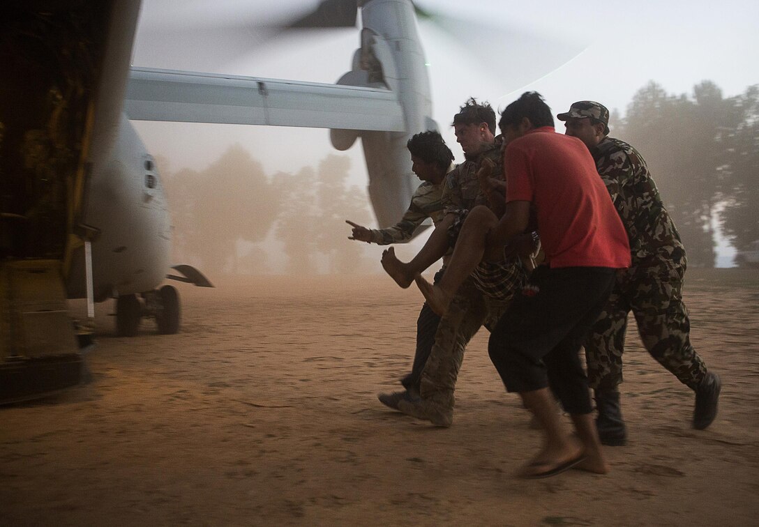 Combat Operations: An Air Force pararescueman with Joint Task Force 505 helps evacuate earthquake victims near Cherikot, Nepal, May 12. The task force, other multinational forces and humanitarian relief organizations provided aid after a 7.8 magnitude earthquake struck the country April 25. Marine Corps photo by Jeffrey D. Anderson