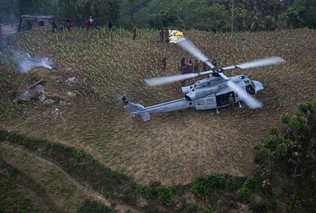 Combat Operations: Nepalese soldiers unload aid and relief supplies delivered by Joint Task Force 505, from a UH-1Y Venom during Operation Sahayogi Haat in Kavrepalanchowk District, Nepal, May 11, 2015. The government of Nepal requested U.S. assistance after a 7.8 magnitude earthquake struck the country, April 25, 2015. Marine Corps photo by Jeffrey D. Anderson