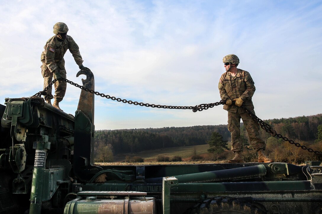 Soldiers secure a chain to a vehicle while participating in vehicle recovery training during Exercise Saber Junction 16 at Hohenfels, Germany, April 5, 2016. Army photo by Pfc. Randy Wren