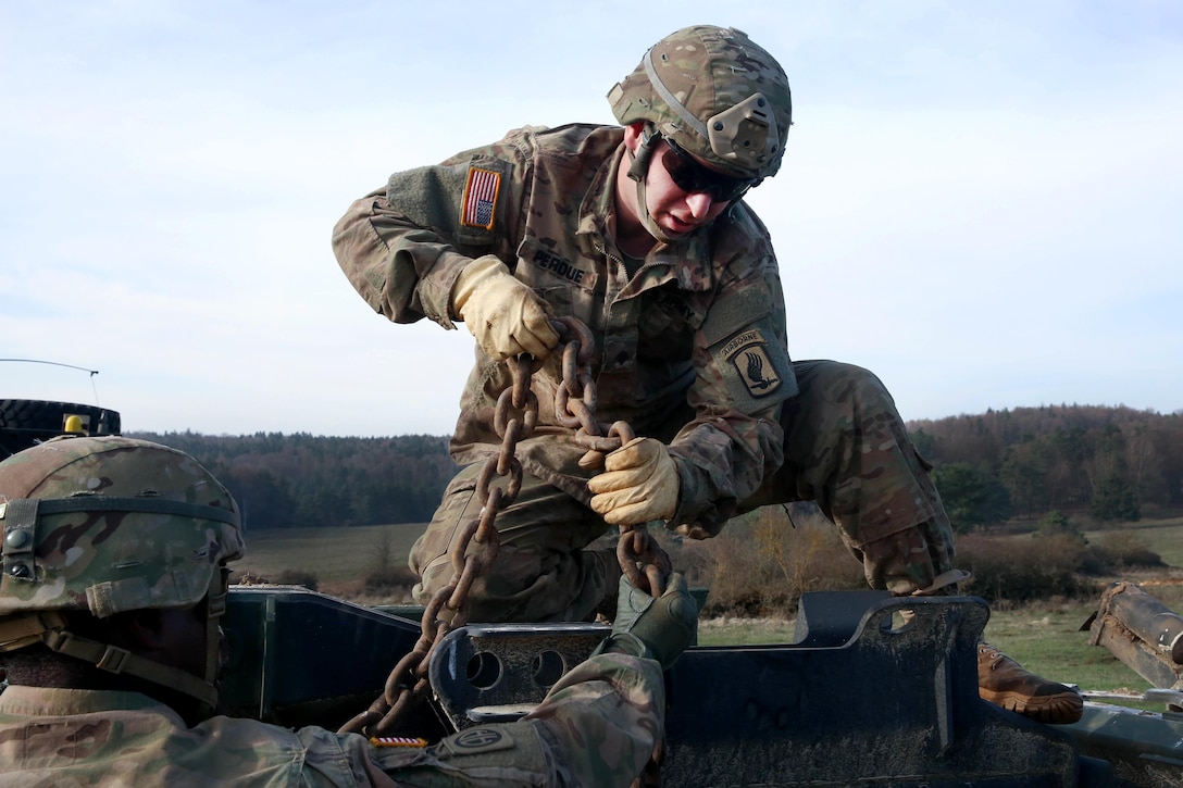 Army Spc. Perdue, center, and another soldier secure chains while participating in vehicle recovery training during Exercise Saber Junction 16 at Hohenfels, Germany, April 5, 2016. Perdue is assigned to the 173rd Brigade Support Battalion, 173rd Airborne Brigade. Army photo by Pfc. Randy Wren
