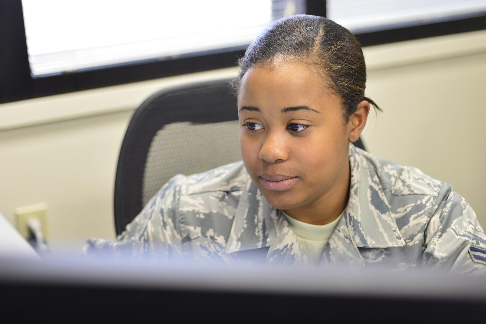 Airman 1st Class Jaleeza, 432nd Operations Support Squadron host aviation resource manager (HARM), updates flight records April 14, 2016, at Creech Air Force Base, Nevada. The HARM office manages all the aircrew members on base by keeping flight records, essential documents, and aeronautical orders. (U.S. Air Force photo by Senior Airman Christian Clausen/Released)